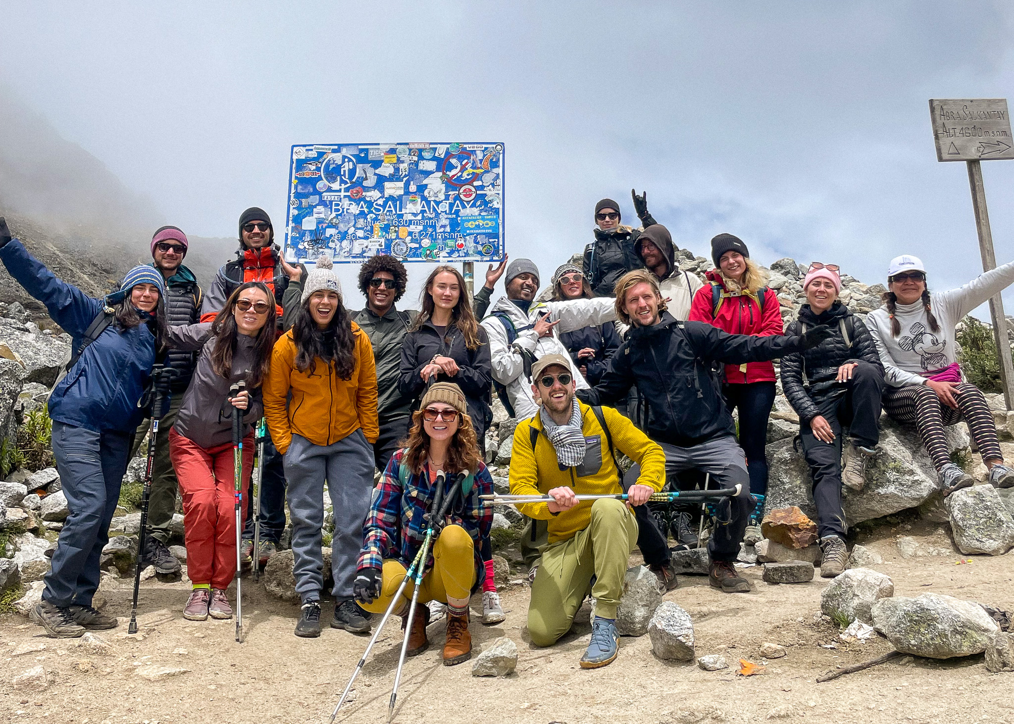 Salkantay Pass Thais And Kelvyn with their trekking group posing in front of Salkantay pass sign