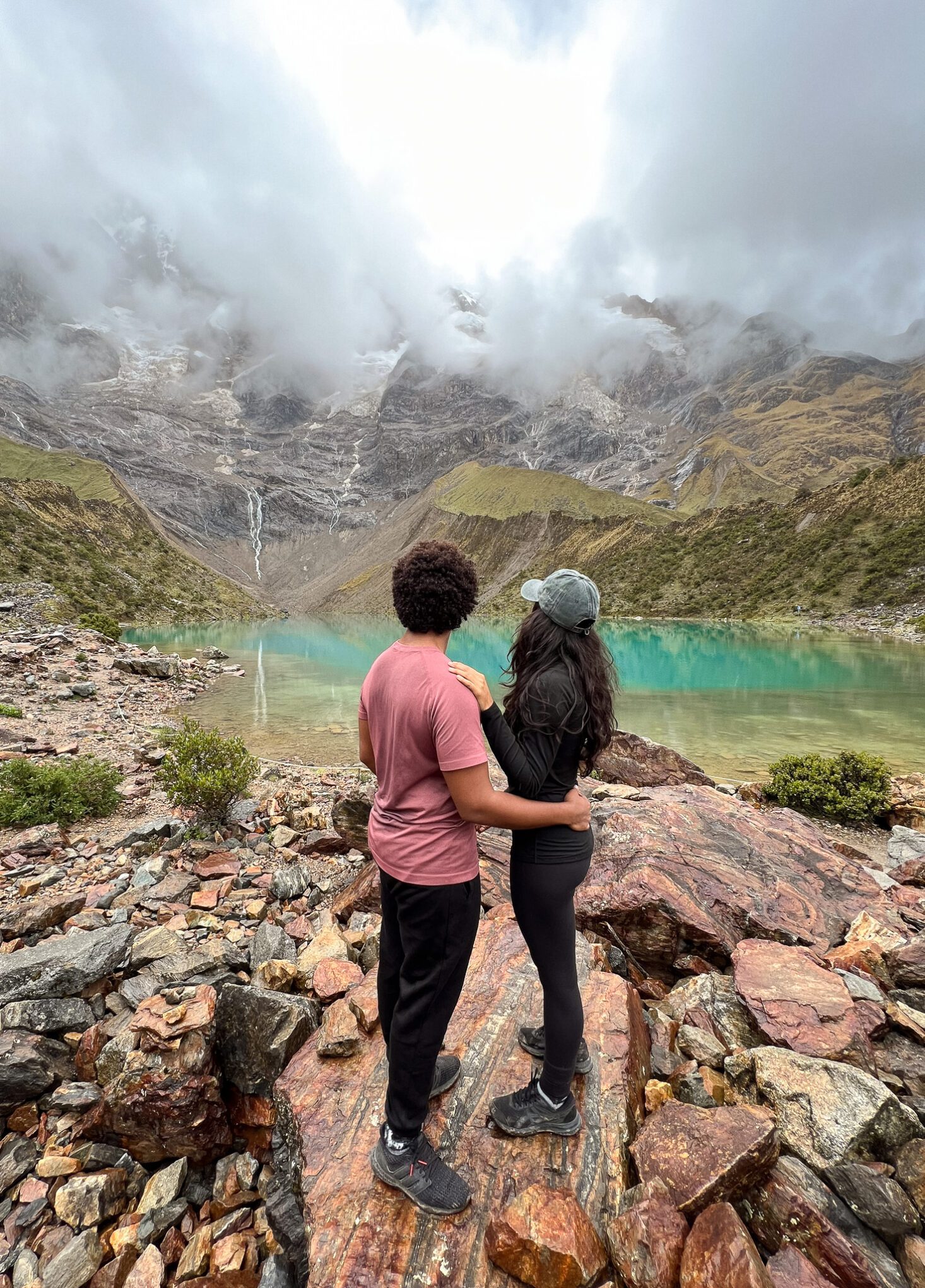 Humantay Lake. Thais and Kelvyn standing on a rock facing the lake 