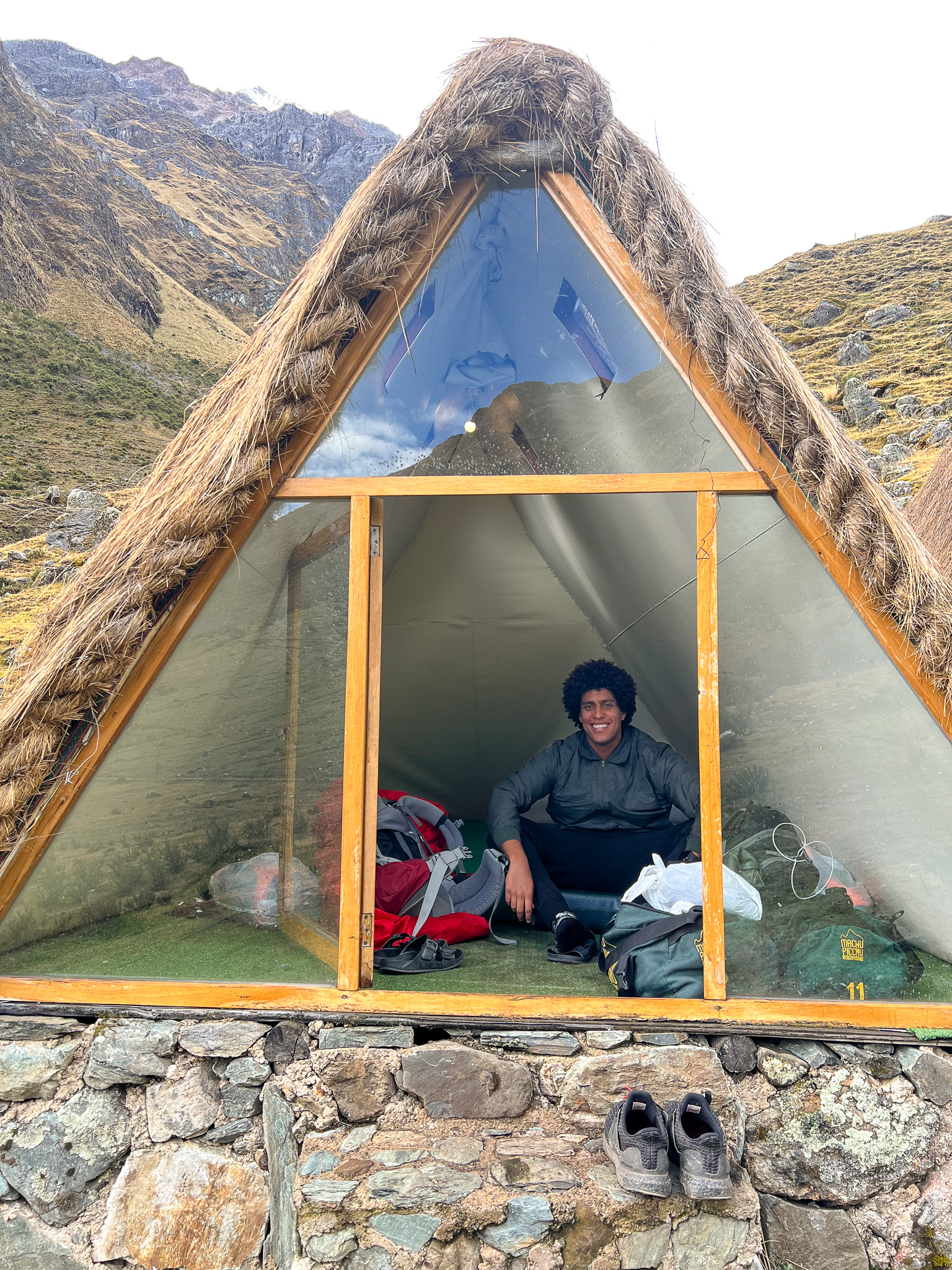 Kelvyn in a Small hut with glass entrance