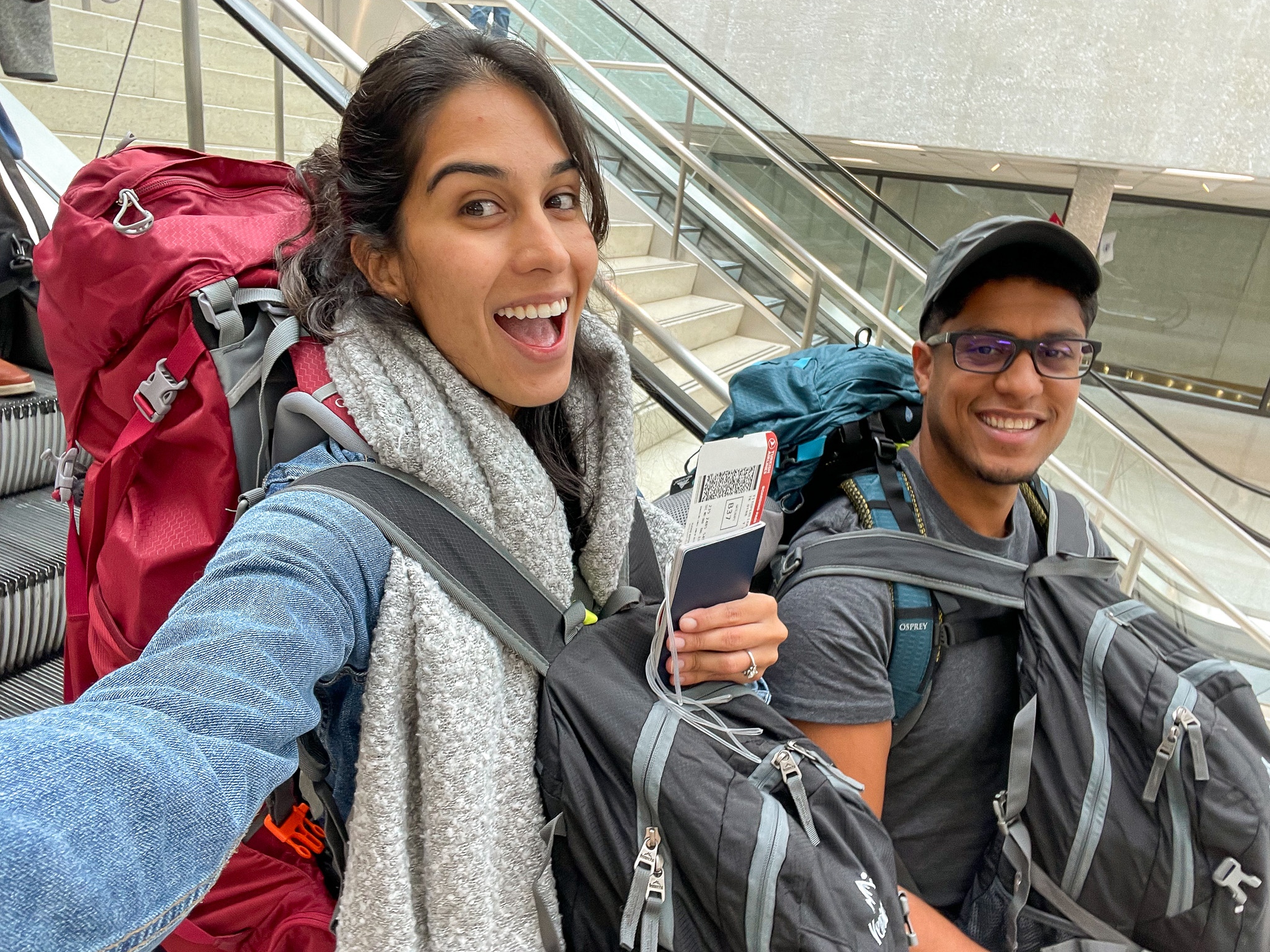 Backpackers: Thais and Kelvyn carrying their backpacks in the airport. Leaving for their firs trip as backpackers in 2022.