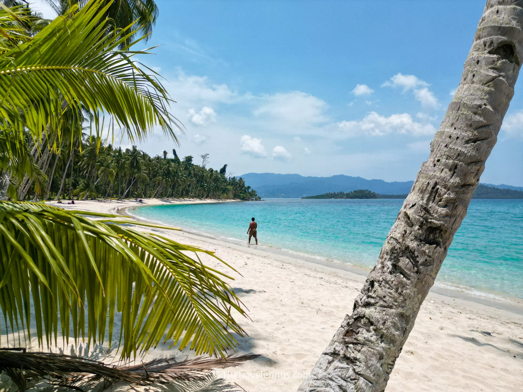 Palawan, Port Barton, white sand beach. Kelvyn walking along the beach 