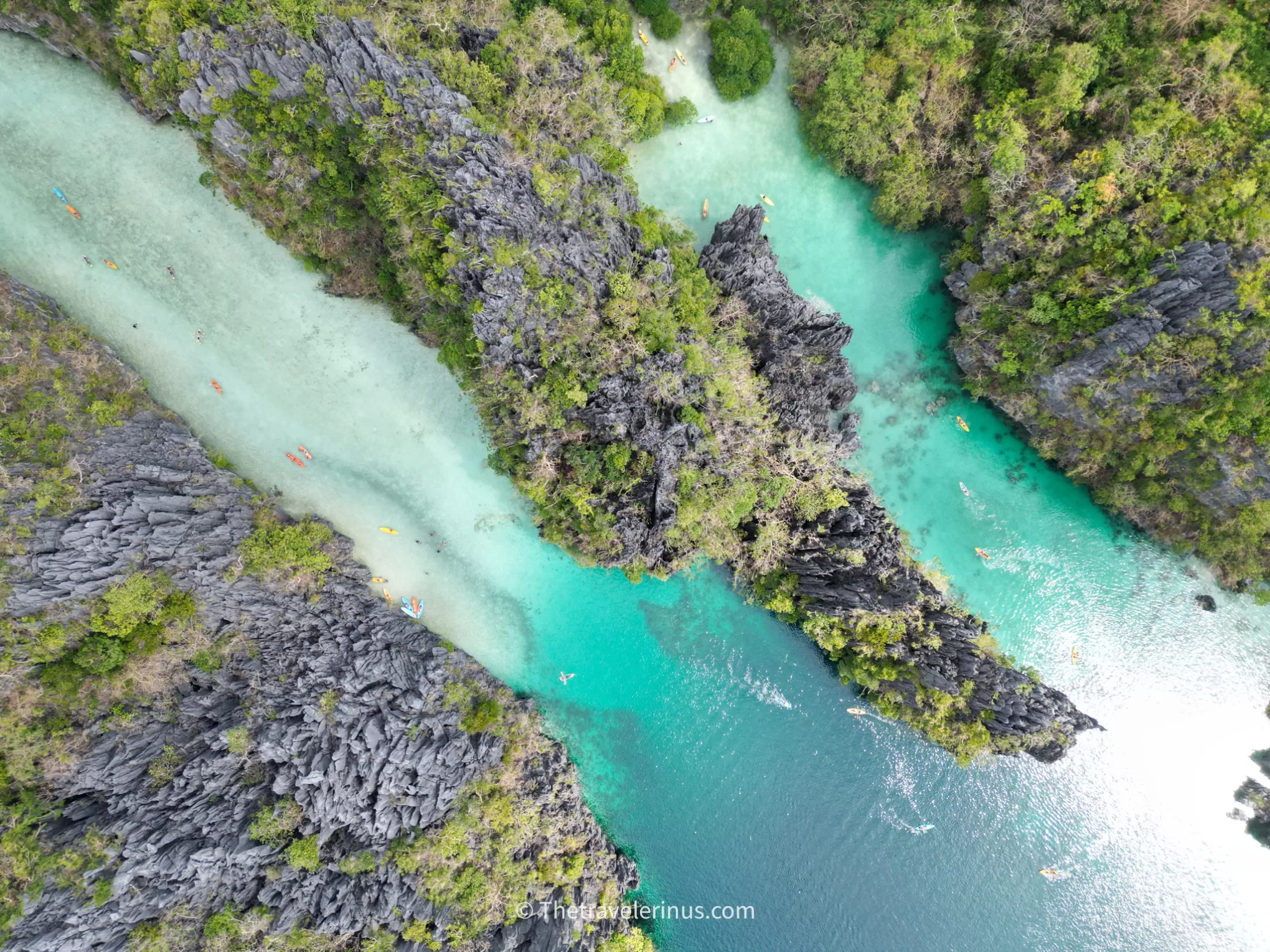 Big lagoon, el Nido Ariel view with trees, rocks, water, and kayaks. most popular place in Palawan