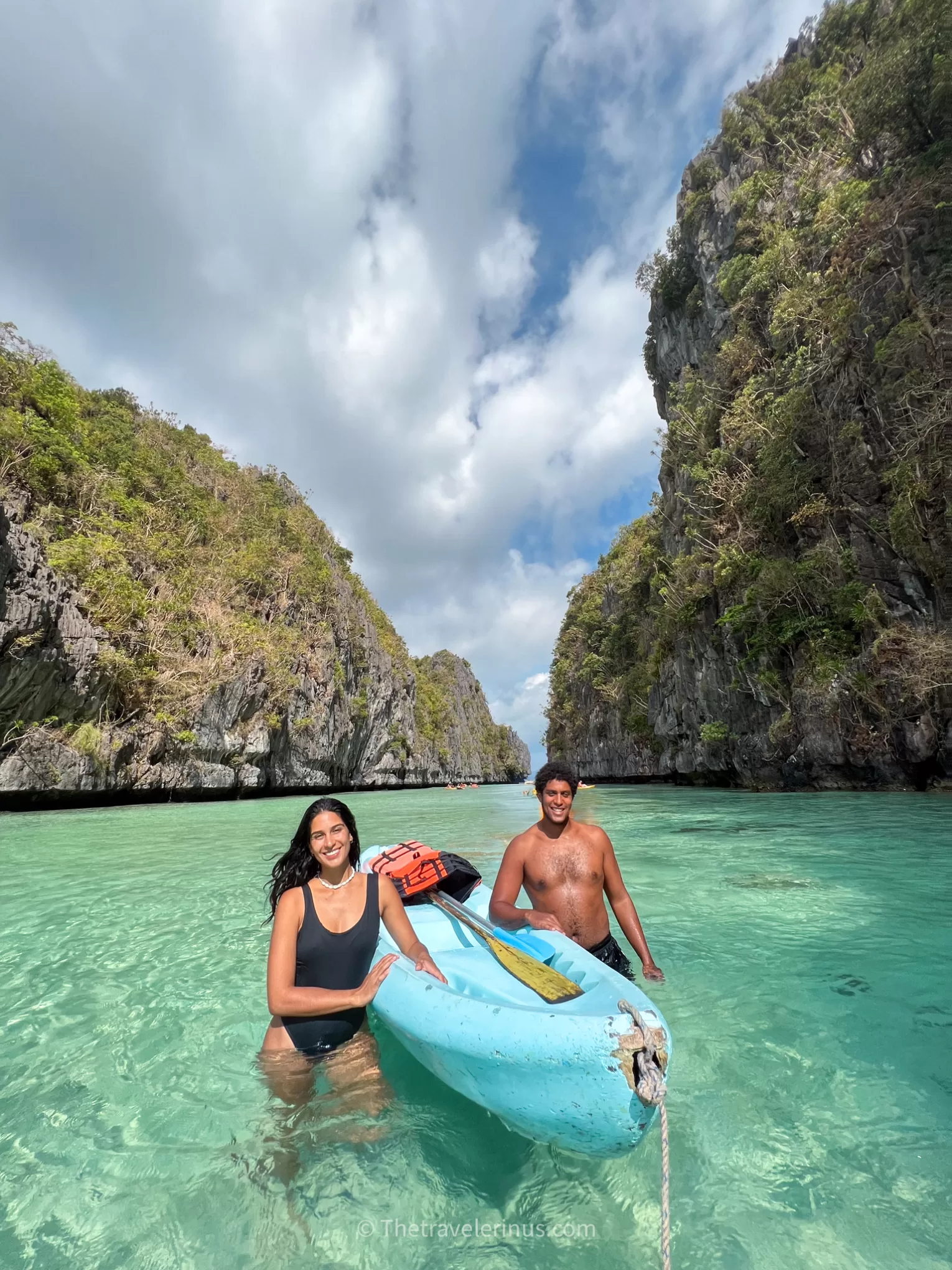 thais and kelvyn next to a kayak on the big lagoon.