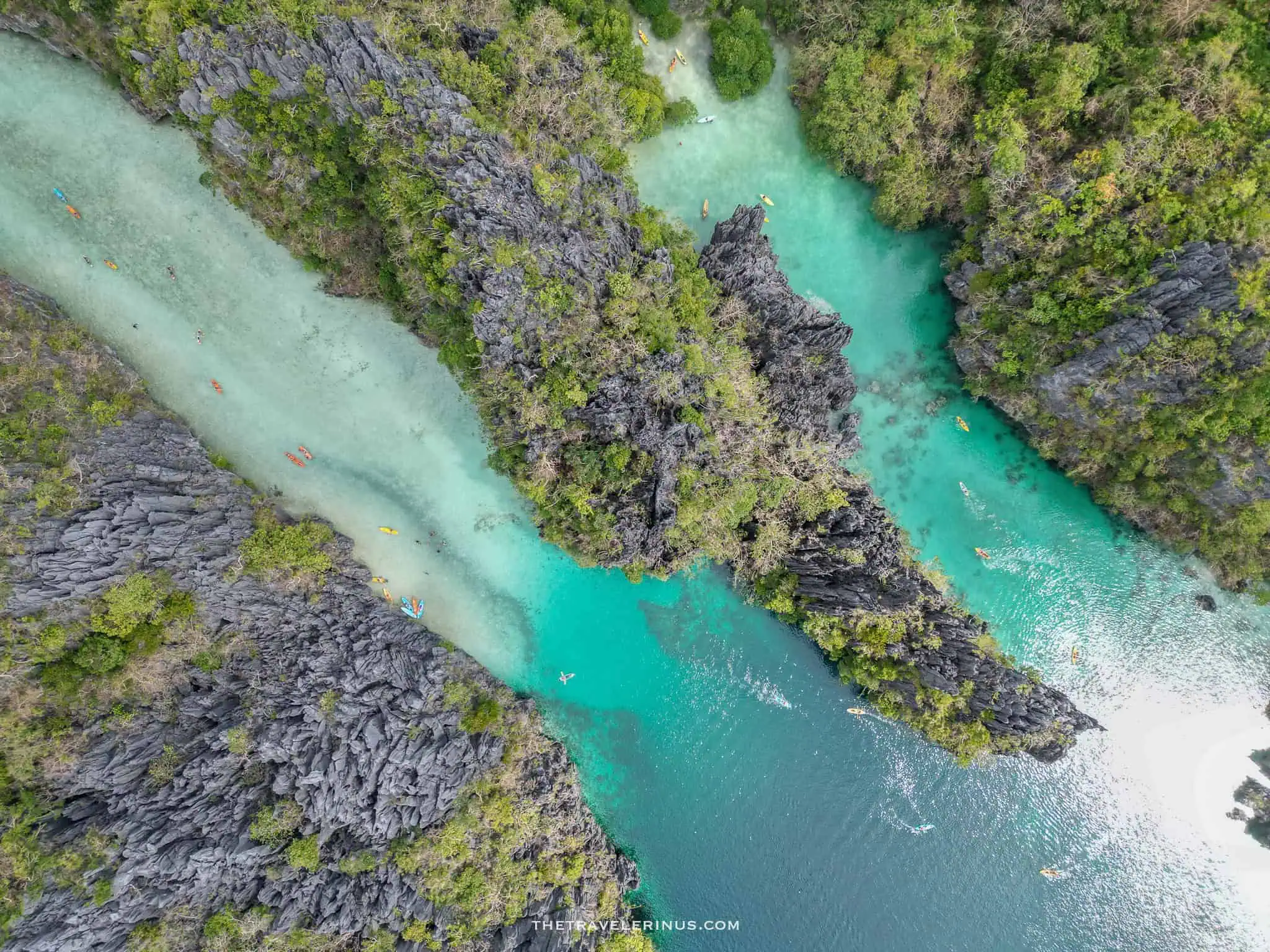 Big lagoon, el Nido Ariel view with trees, rocks, water, and kayaks. most popular place in Palawan