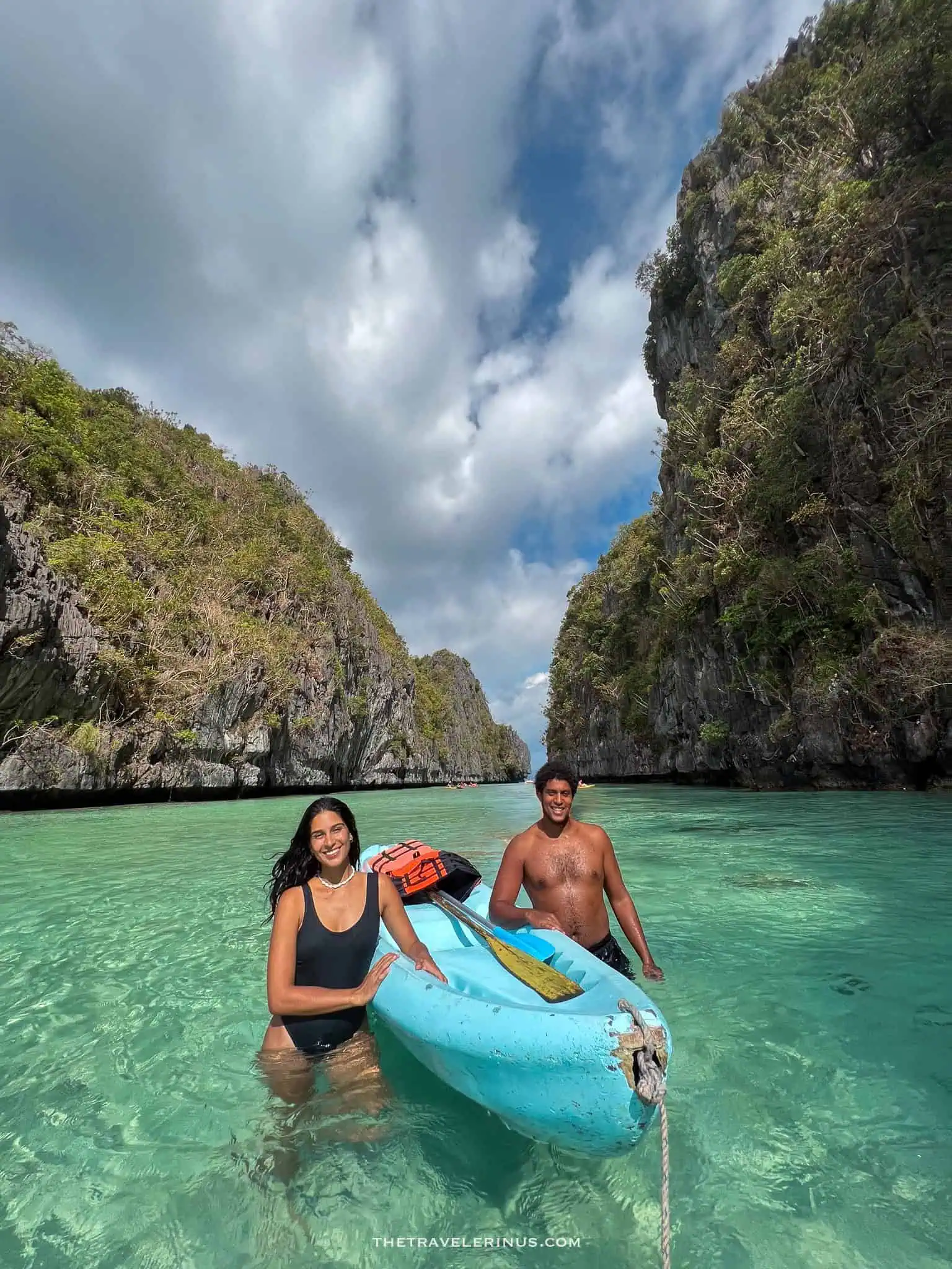 thais and kelvyn next to a kayak on the big lagoon.