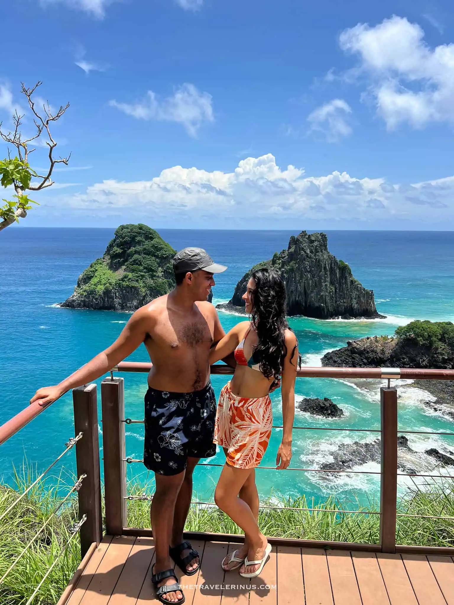 thais and kelvyn posing from a lookout point with views of dois irmaos, Fernando de Noronha 