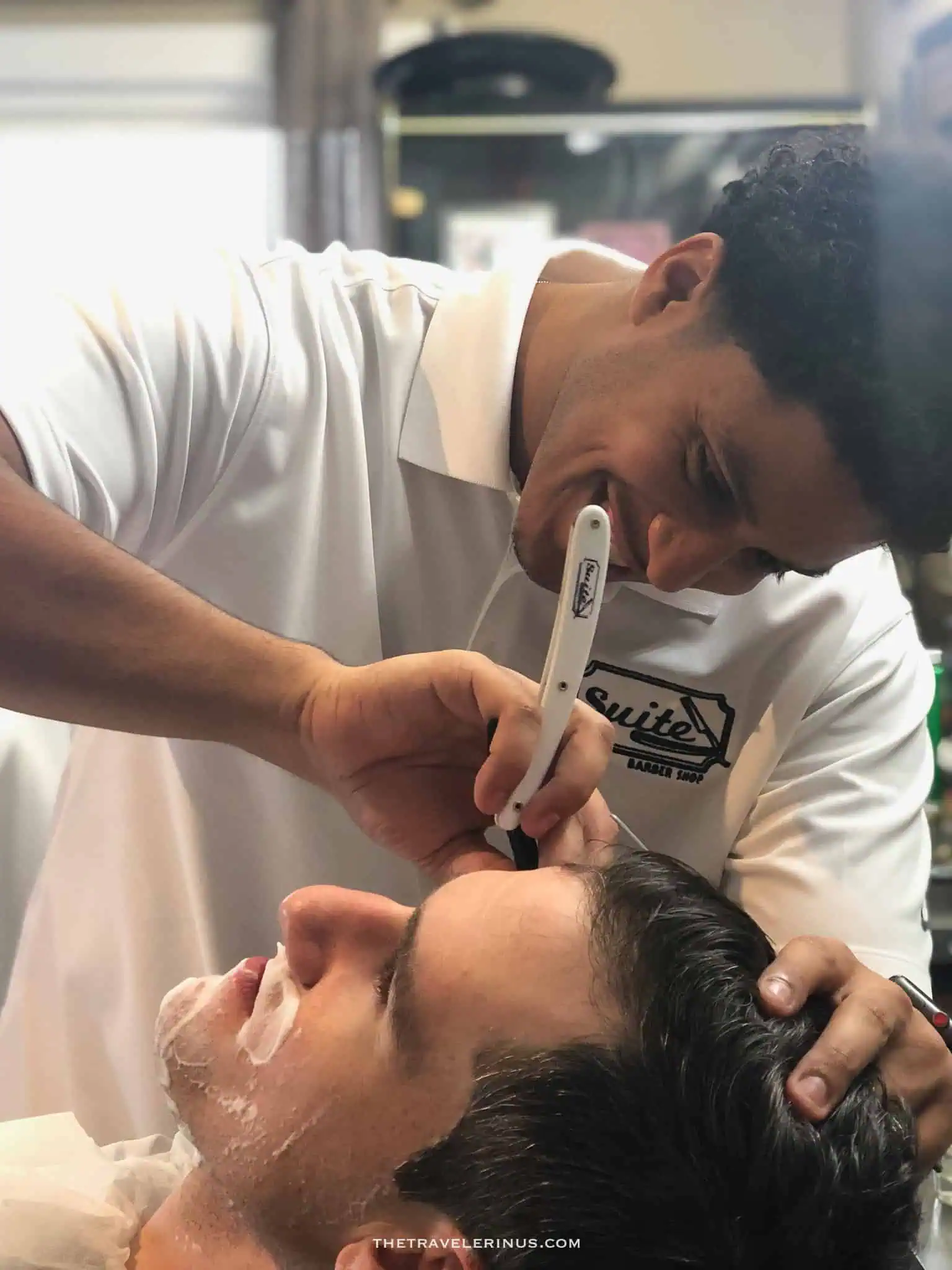 kelvyn giving a shave to a client