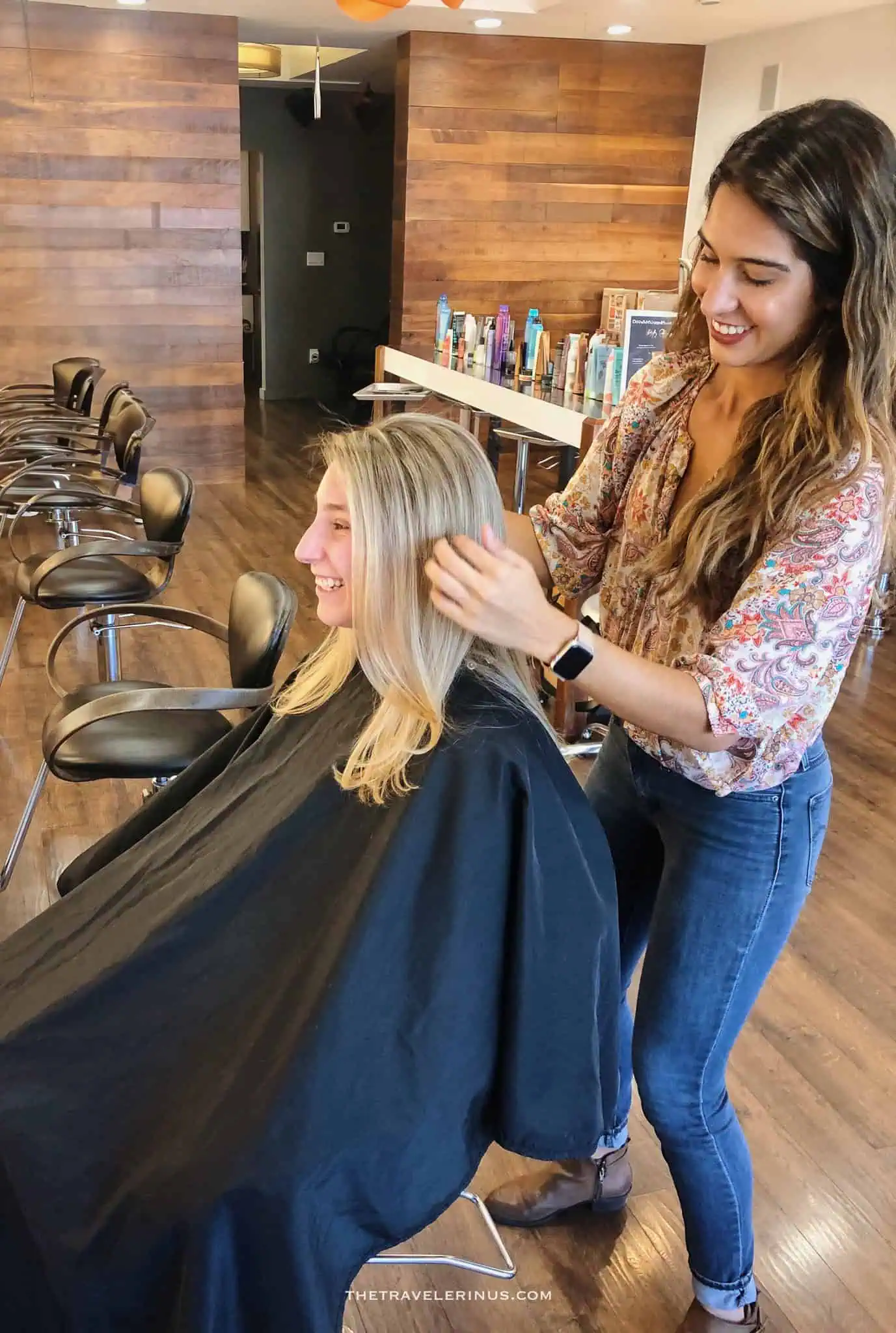 thais styling a clients hair at a salon